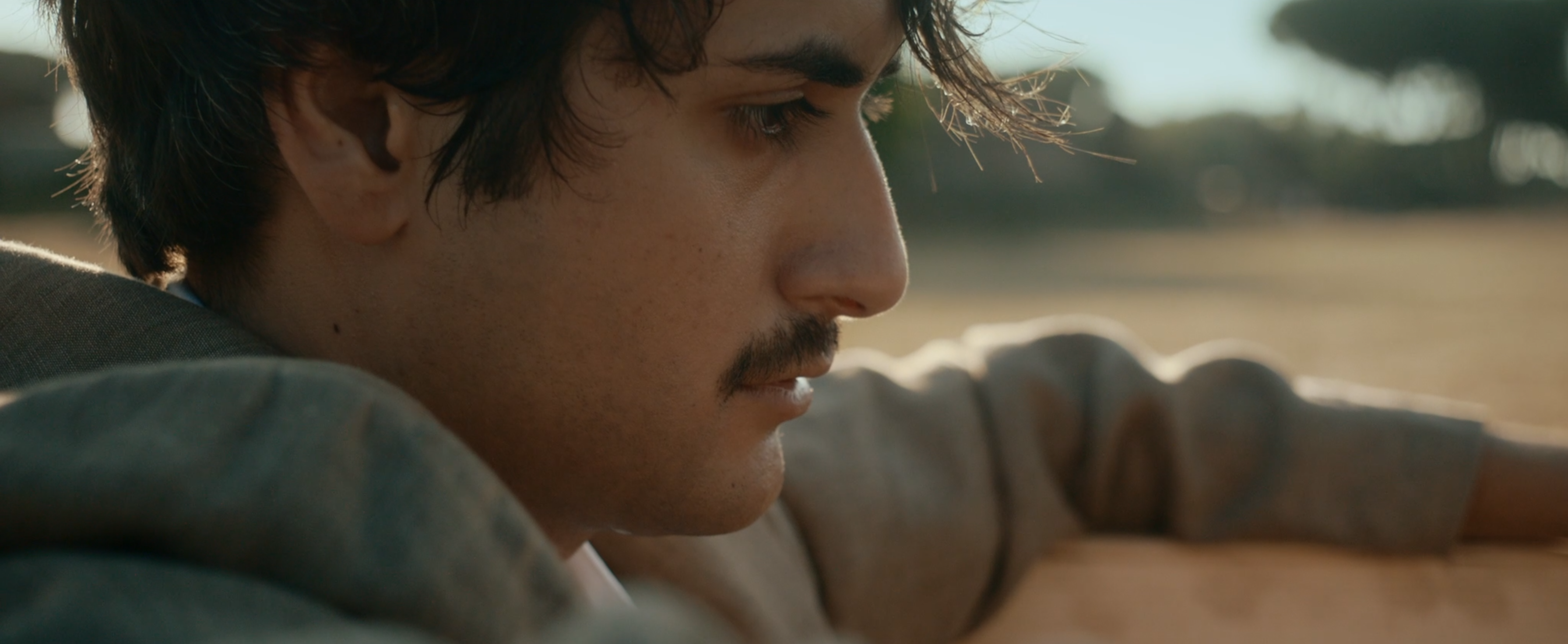 A close-up of a man outdoors in daylight