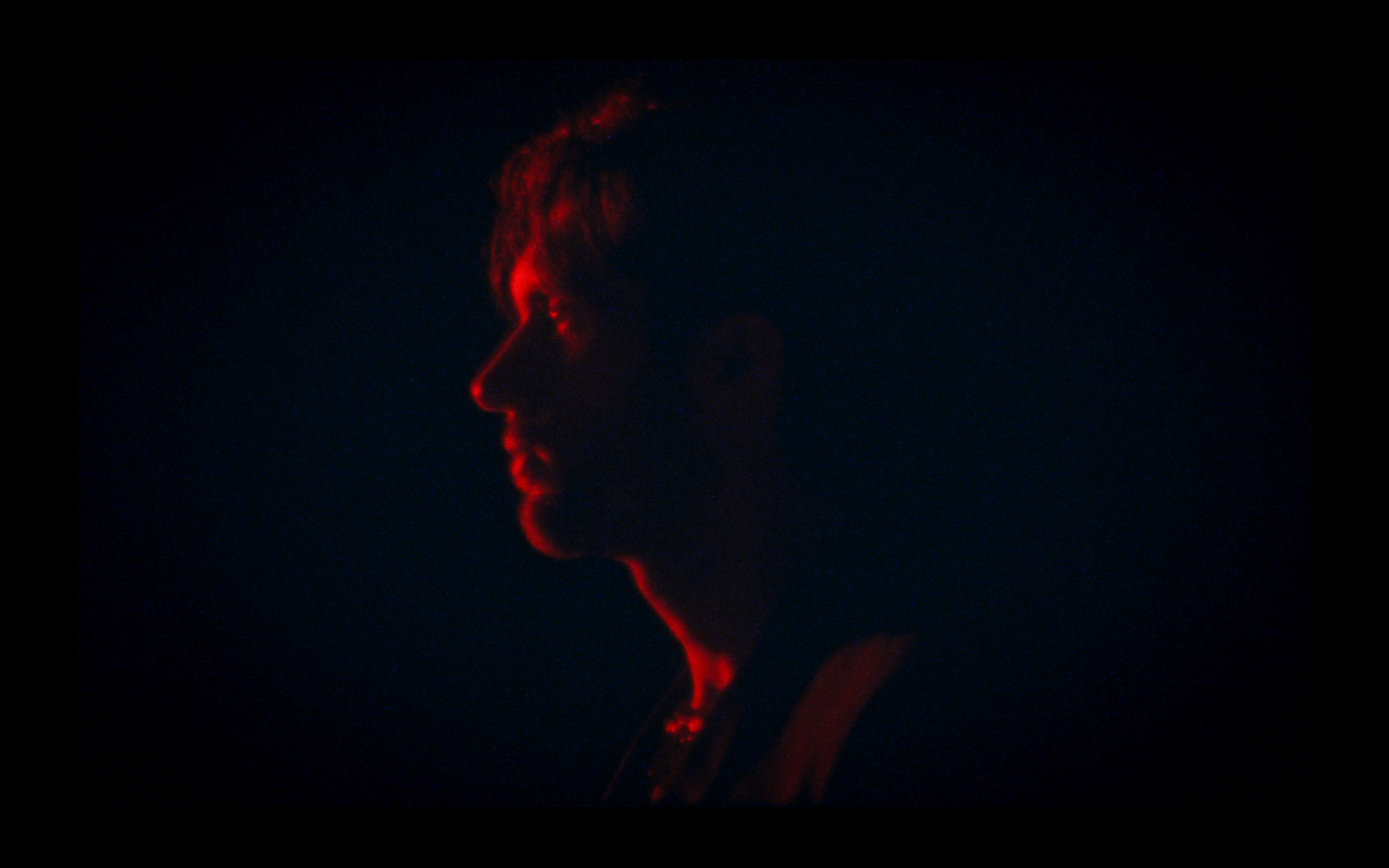 A profile lit in red