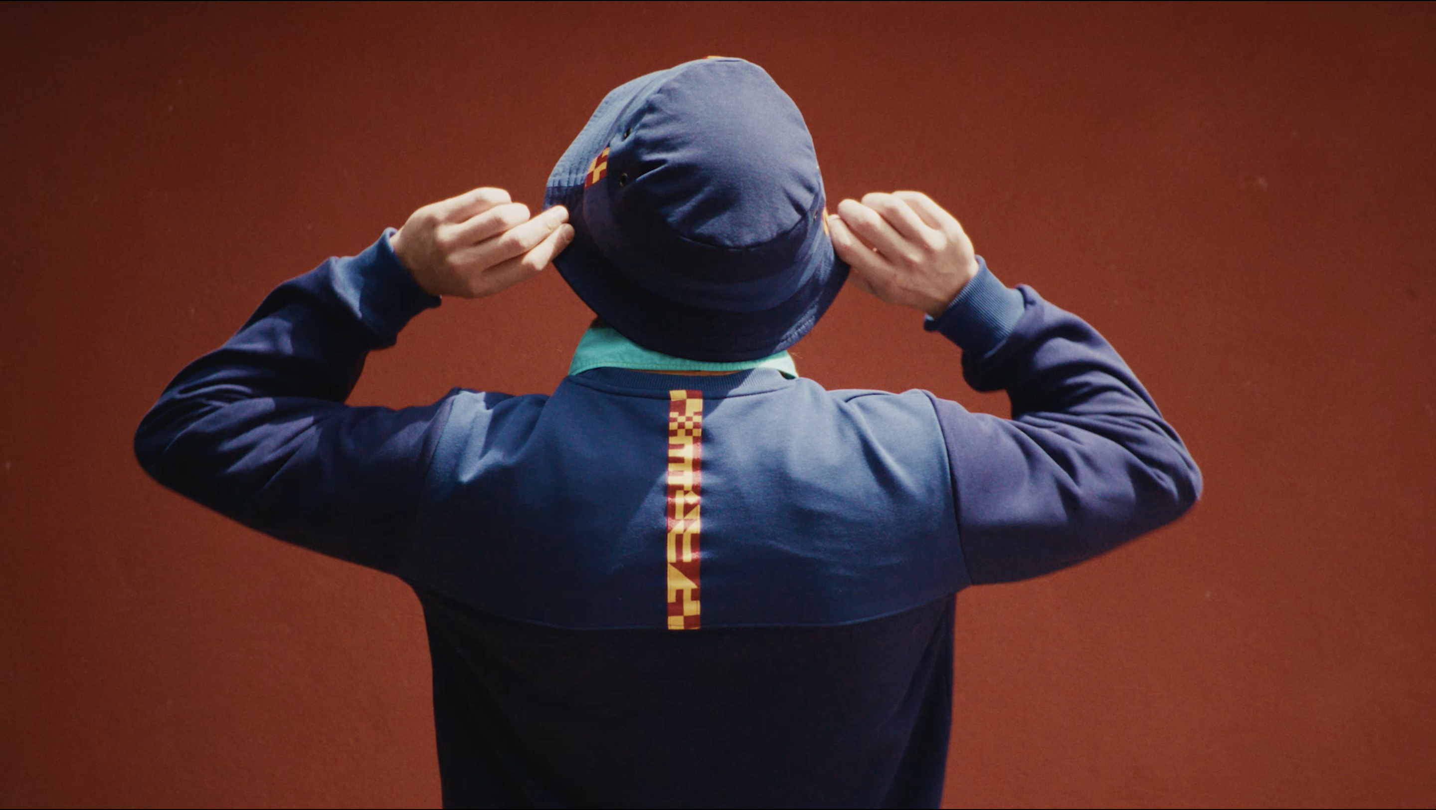 An AS Roma bucket hat against a terracotta wall