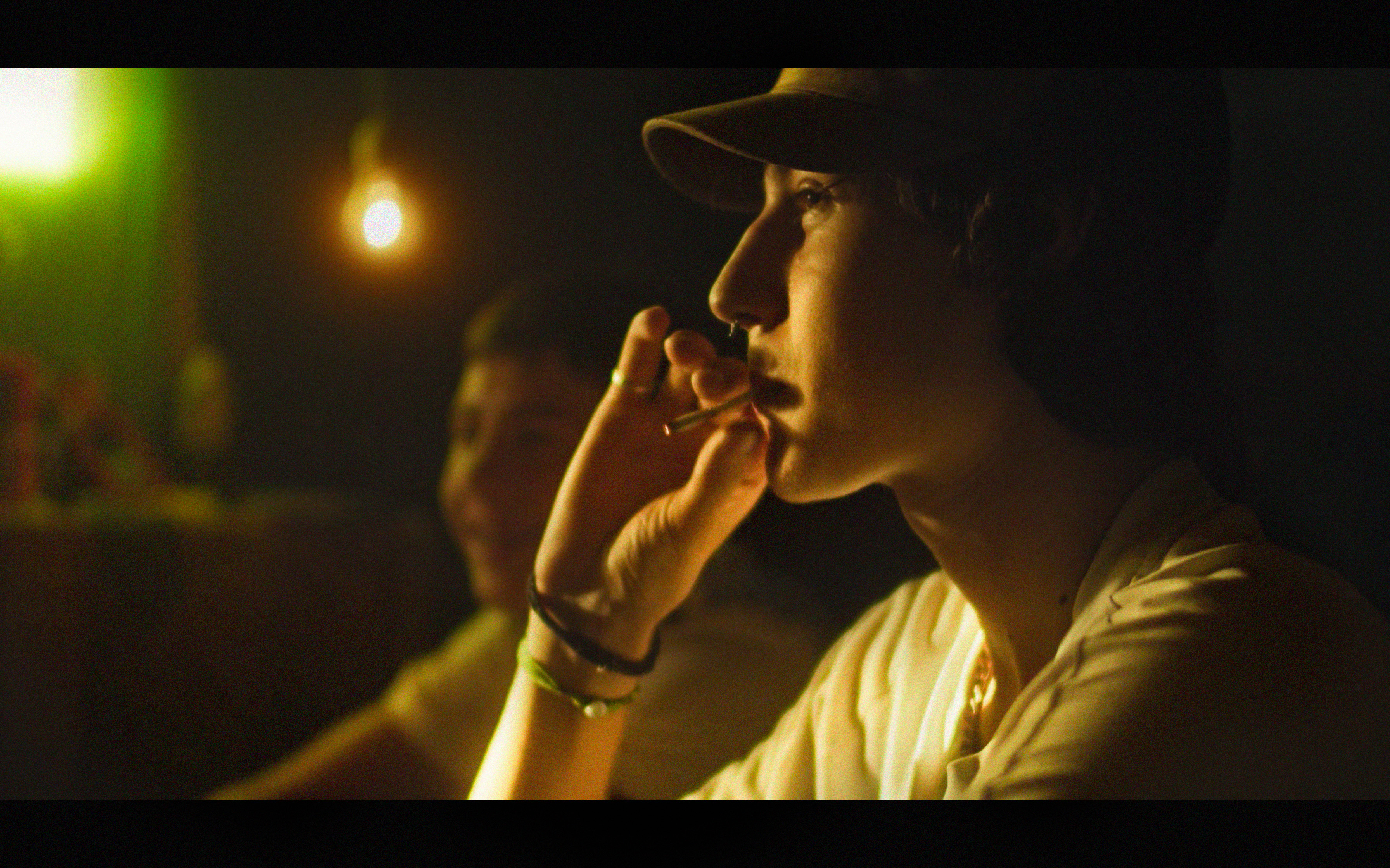 A woman in a cap in warm green and golden light
