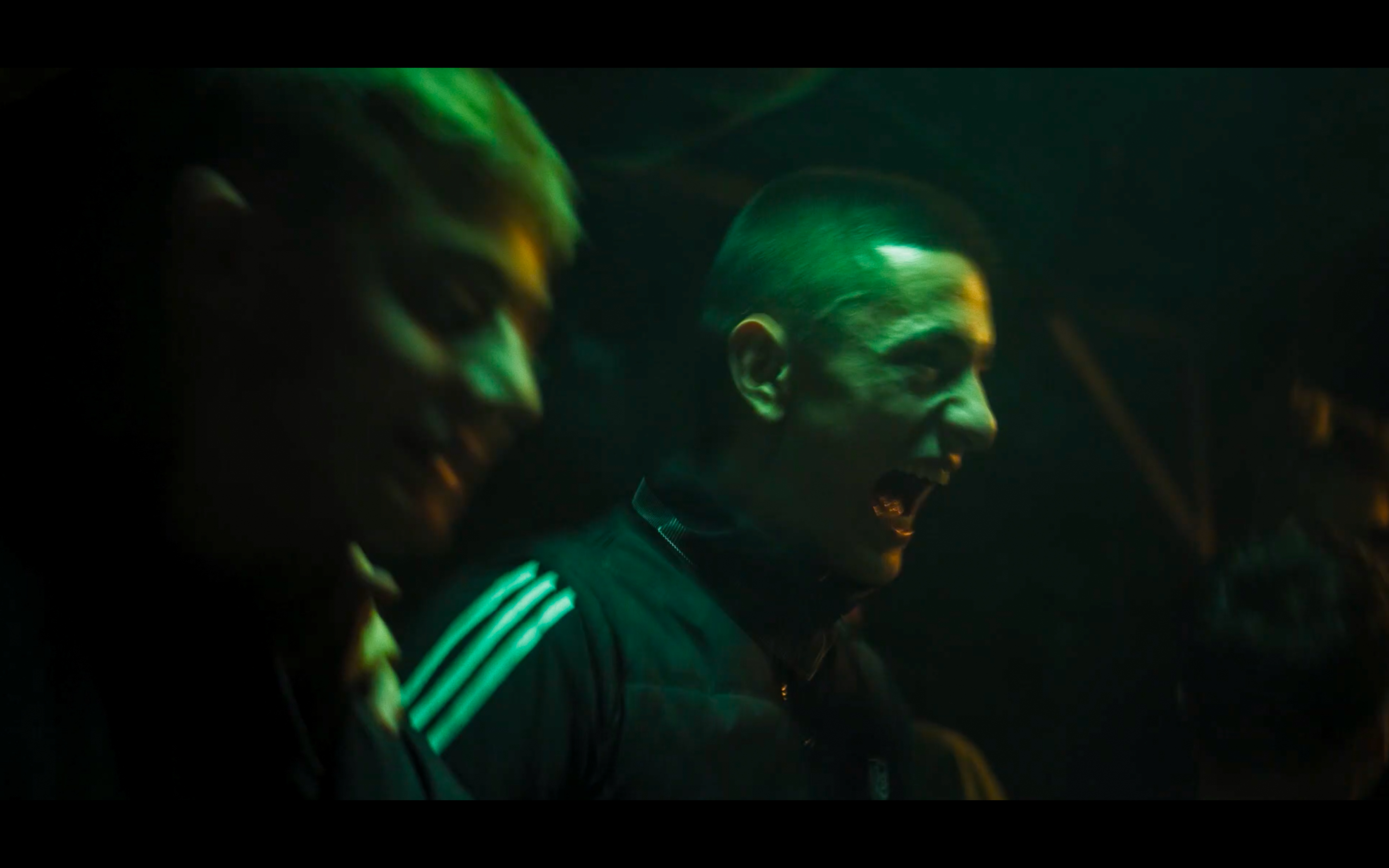 Two people in green light at night