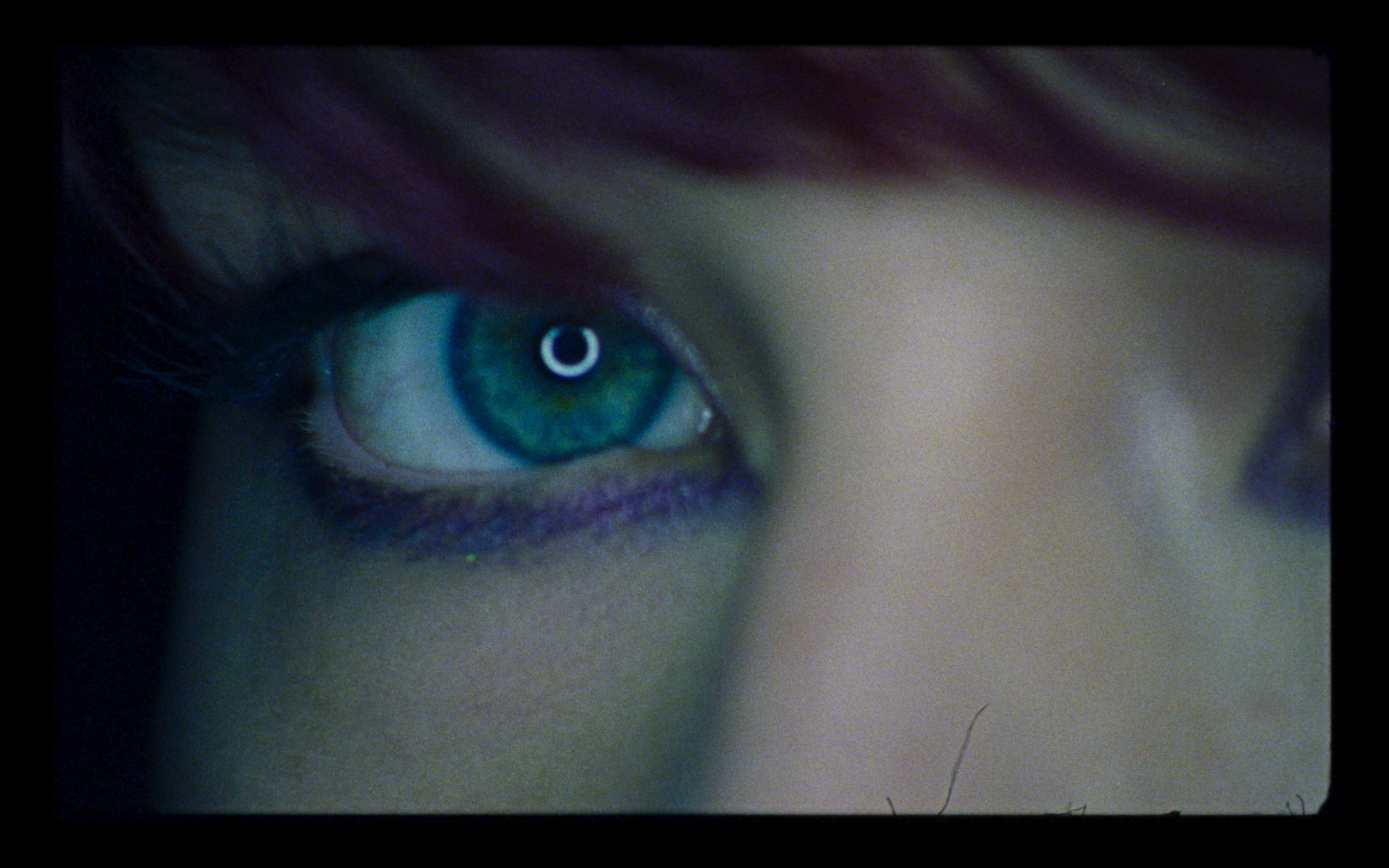 A close-up of an eye in blue light