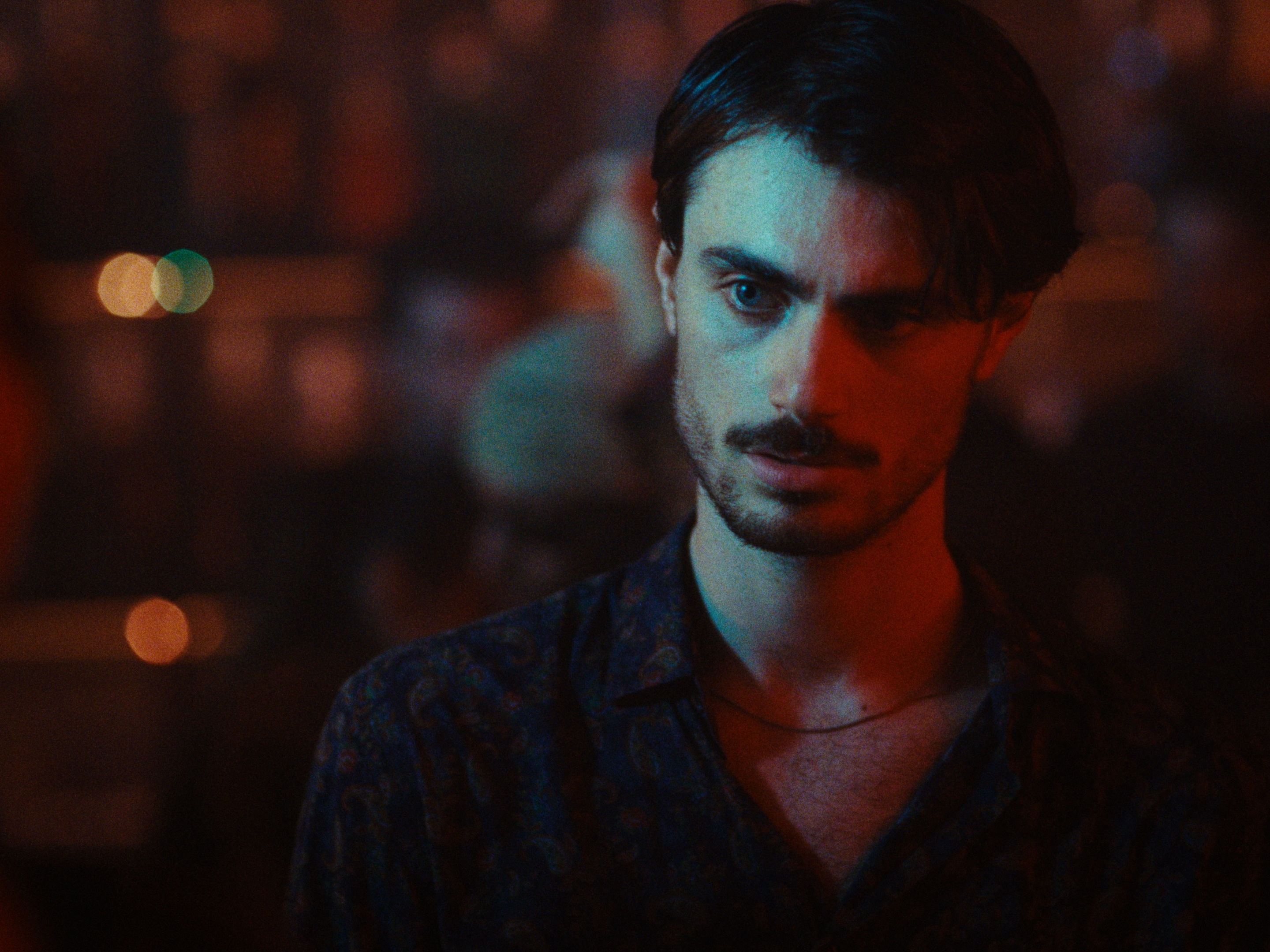 A portrait lit by contrasting blue and red light