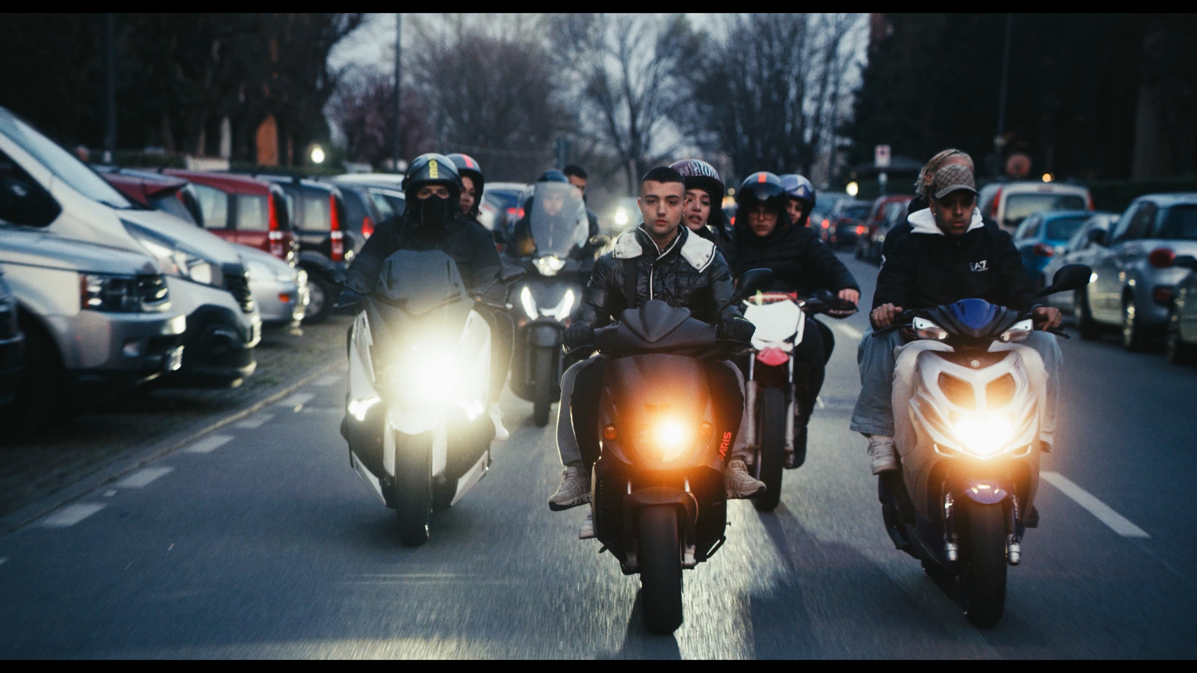 A group riding scooters through the city