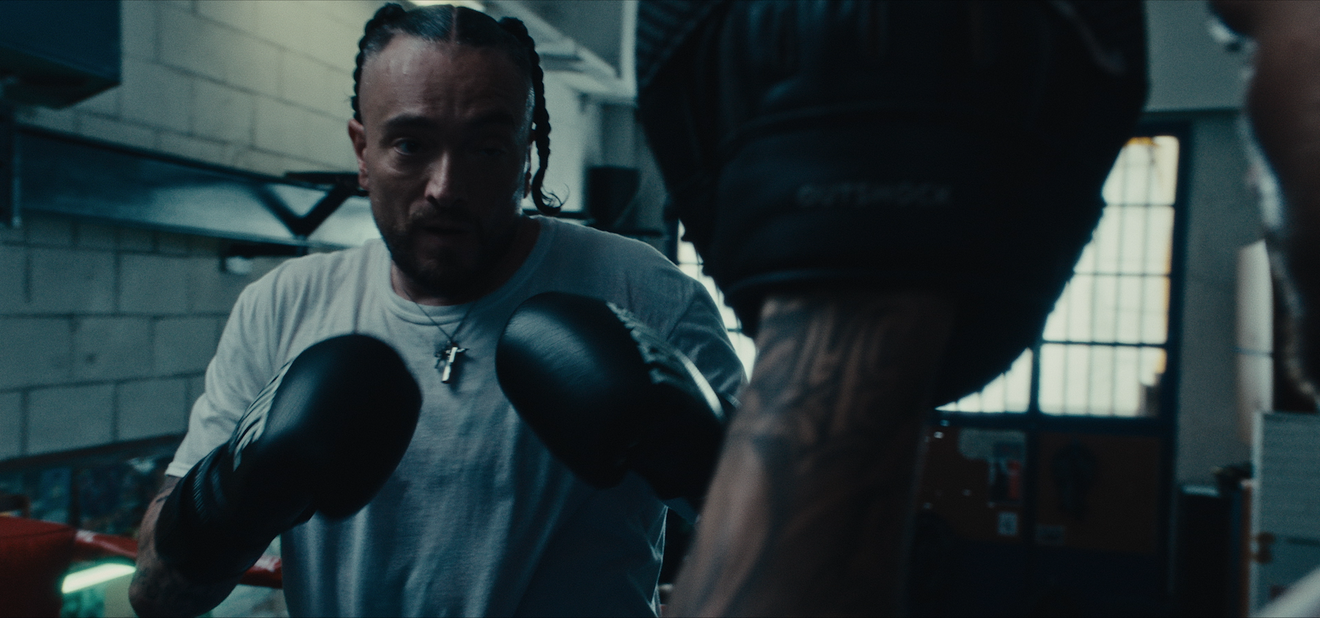 A boxer wearing gloves in a gym